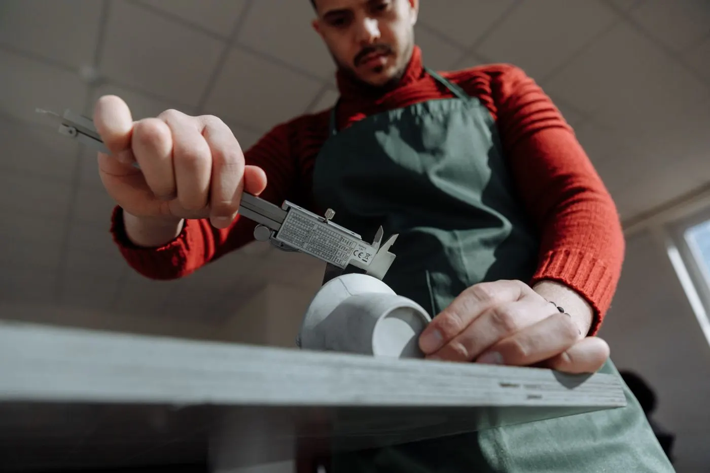Measuring a machined part with a vernier caliper